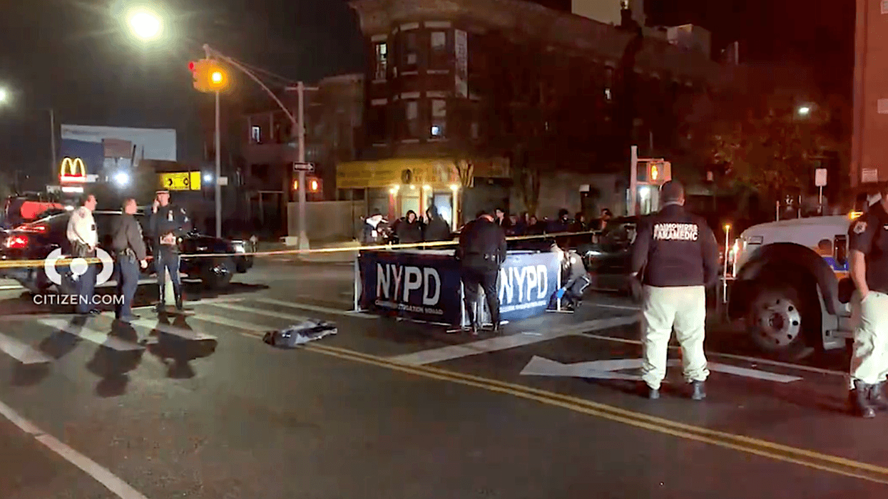 Police put up a barrier to block the body of a man who was struck and killed by two drivers in Borough Park on Tuesday night