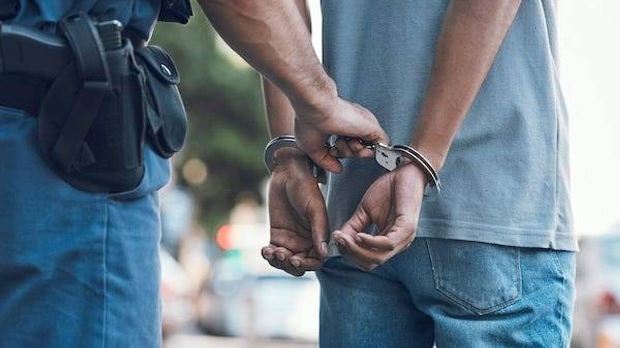 Police putting handcuffs on a man