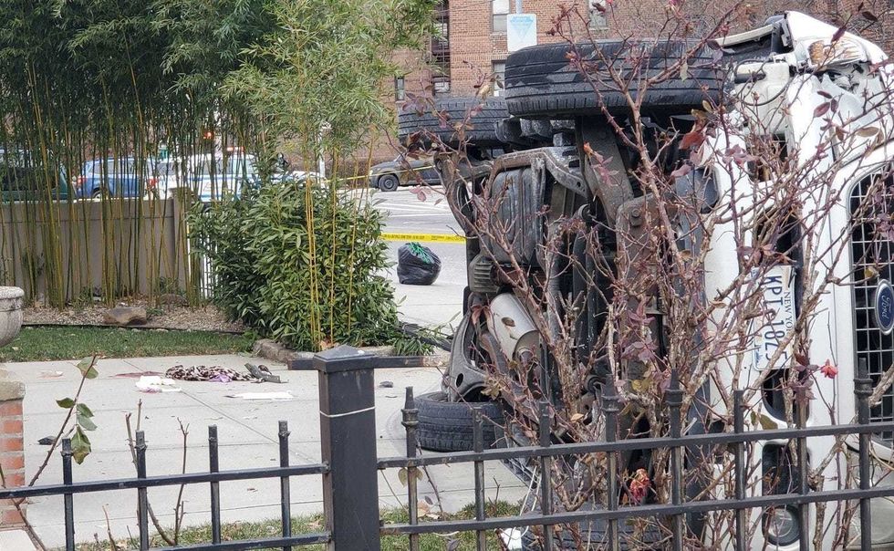 Police said a man struck his wife with an SUV, which landed on its side in front of a home on Parsons Boulevard in Flushing