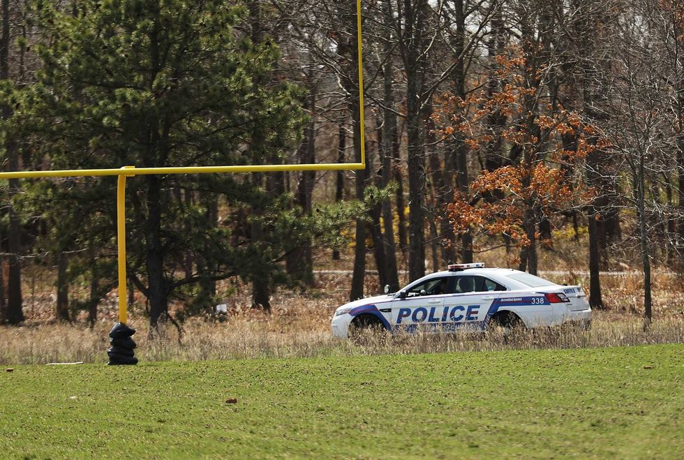Police set up a crime scene at a park in Central Islip, Long Island where four mutilated bodies of young men were found on April 13, 2017 in Central Islip