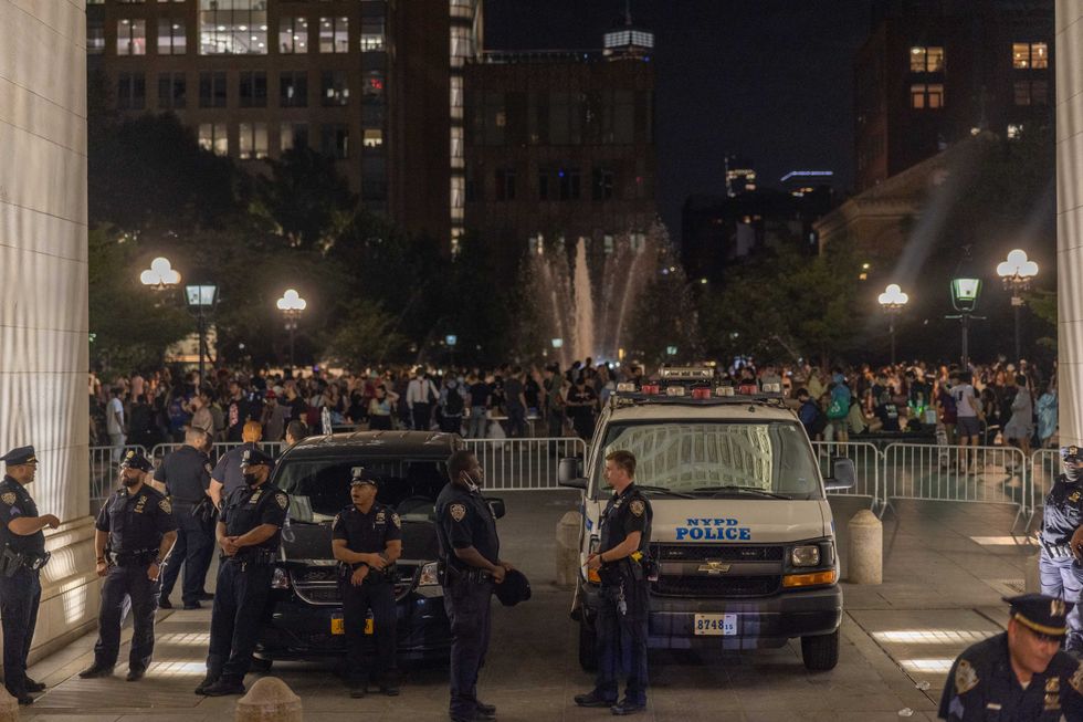 Police set up a perimeter beneath the archway of Washington Square Park on June 18, 2021 in New York City