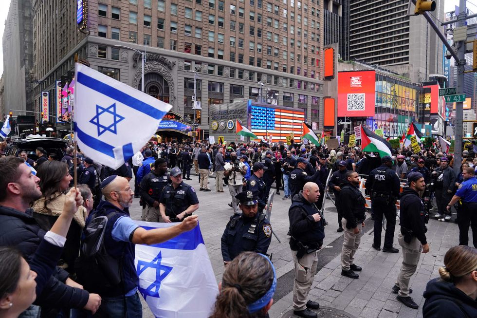 Police stand between dueling rallies in Times Square on Oct. 8, 2023