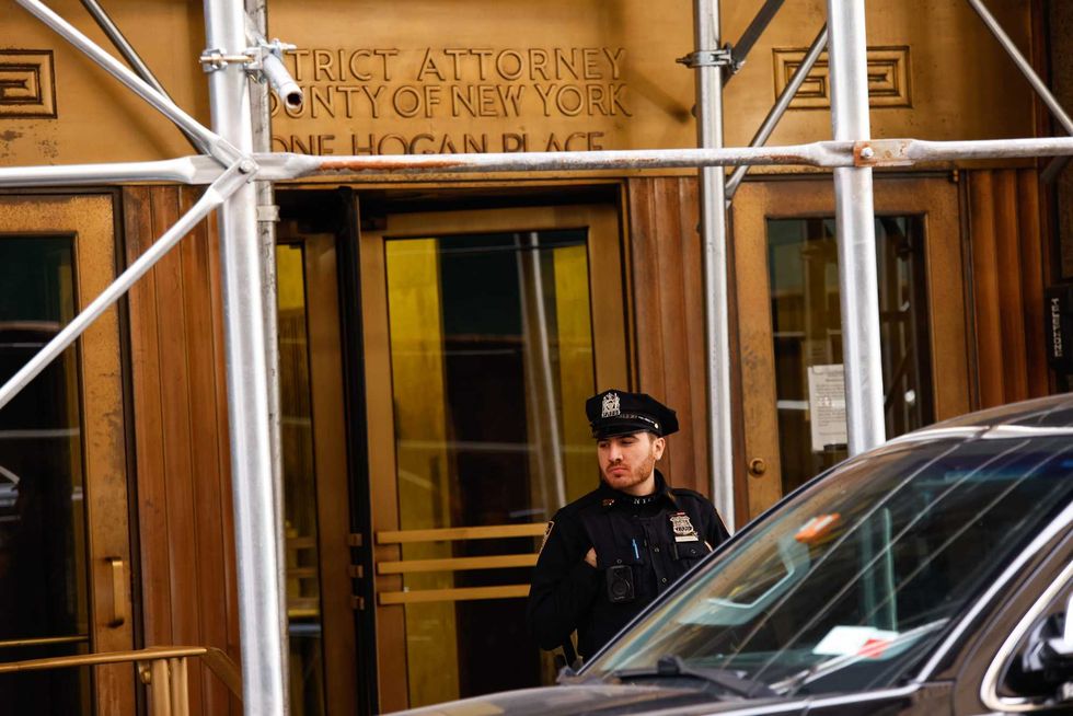 Police stand guard outside the offices of the Manhattan District Attorney on March 31, 2023 in New York City