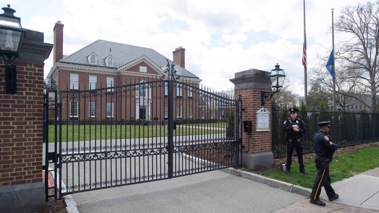 Police stand in front of the Pennsylvania governor's mansion after a portion of the property was damaged in an arson fire overnight on April 13, 2025, in Harrisburg, Pennsylvania.