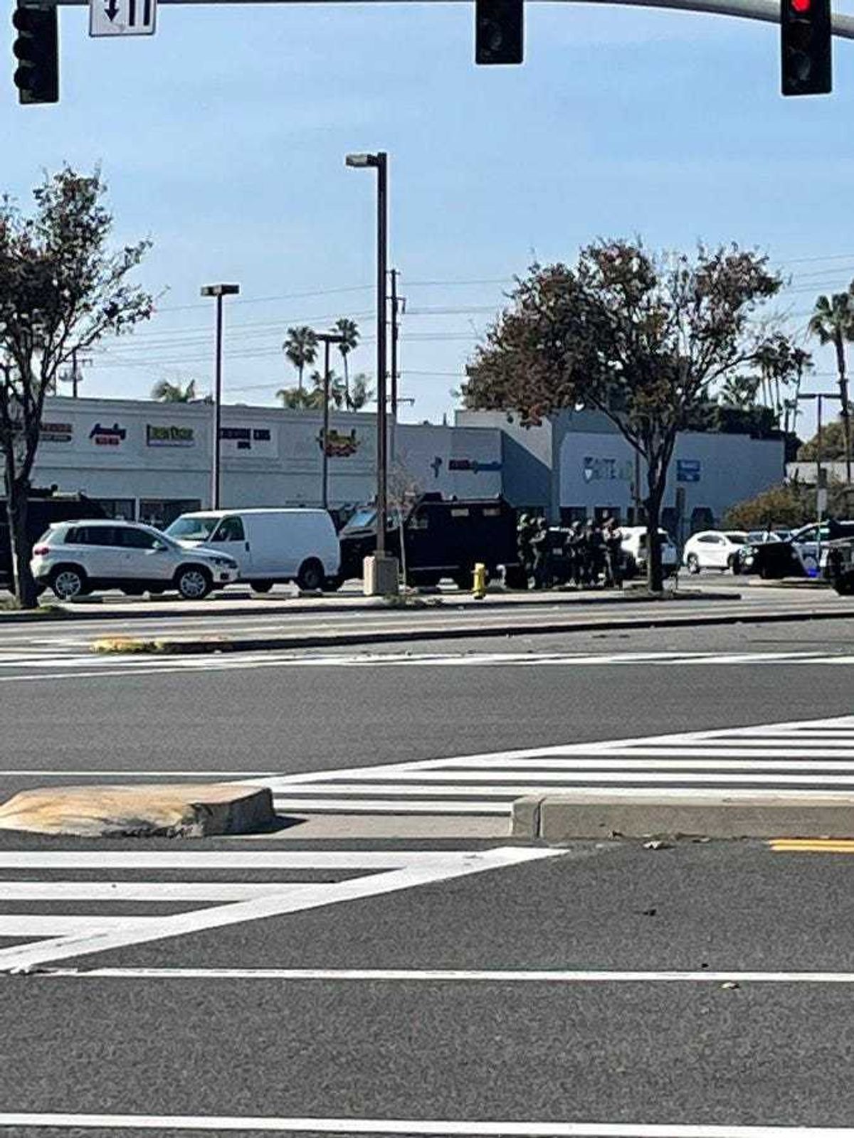 Police standoff with a van in a parking lot in Torrance with the alleged Monterey Park shooter in the passenger seat.