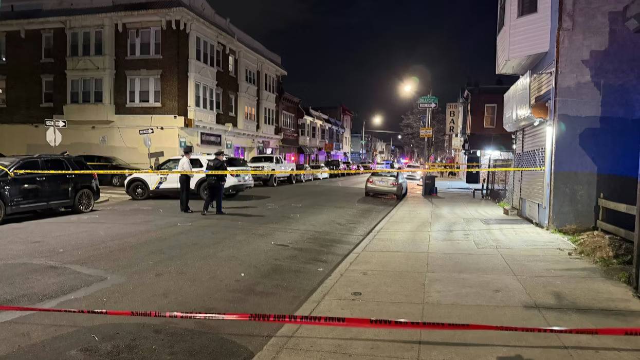 Police tape blocks off the scene at a mass shooting in Cobbs Creek