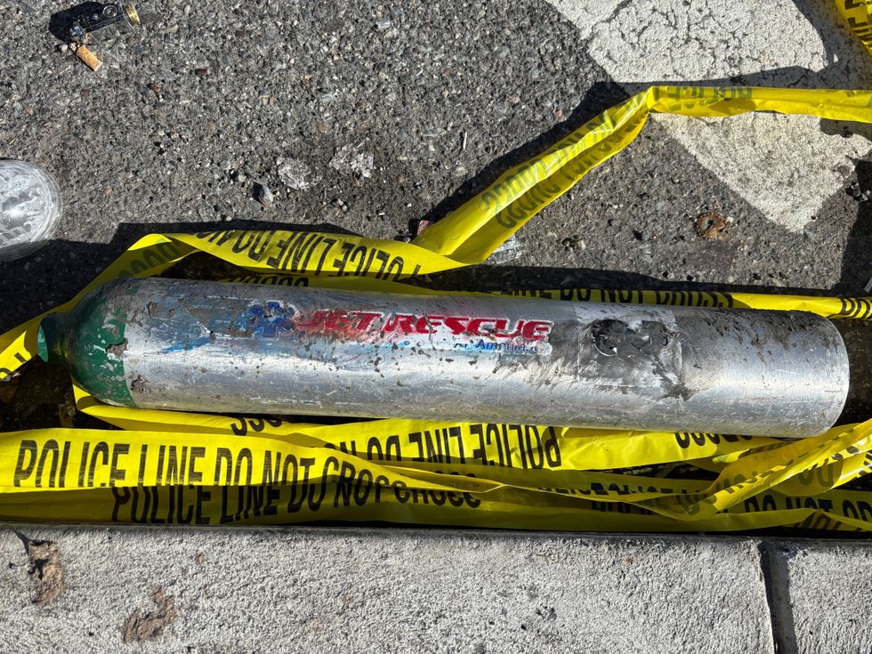 Police tape marks the location on Cottman Avenue where a tank from the plane landed.