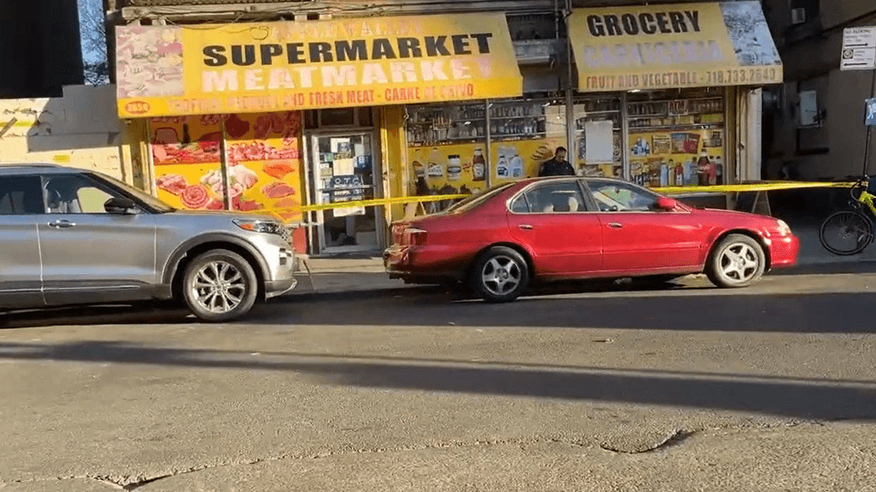 Police tape off the scene to investigate after a man, 48-year-old Padilla Nestor, was found stabbed to death in front of a supermarket at 2631 Marion Ave. in the Bronx.
