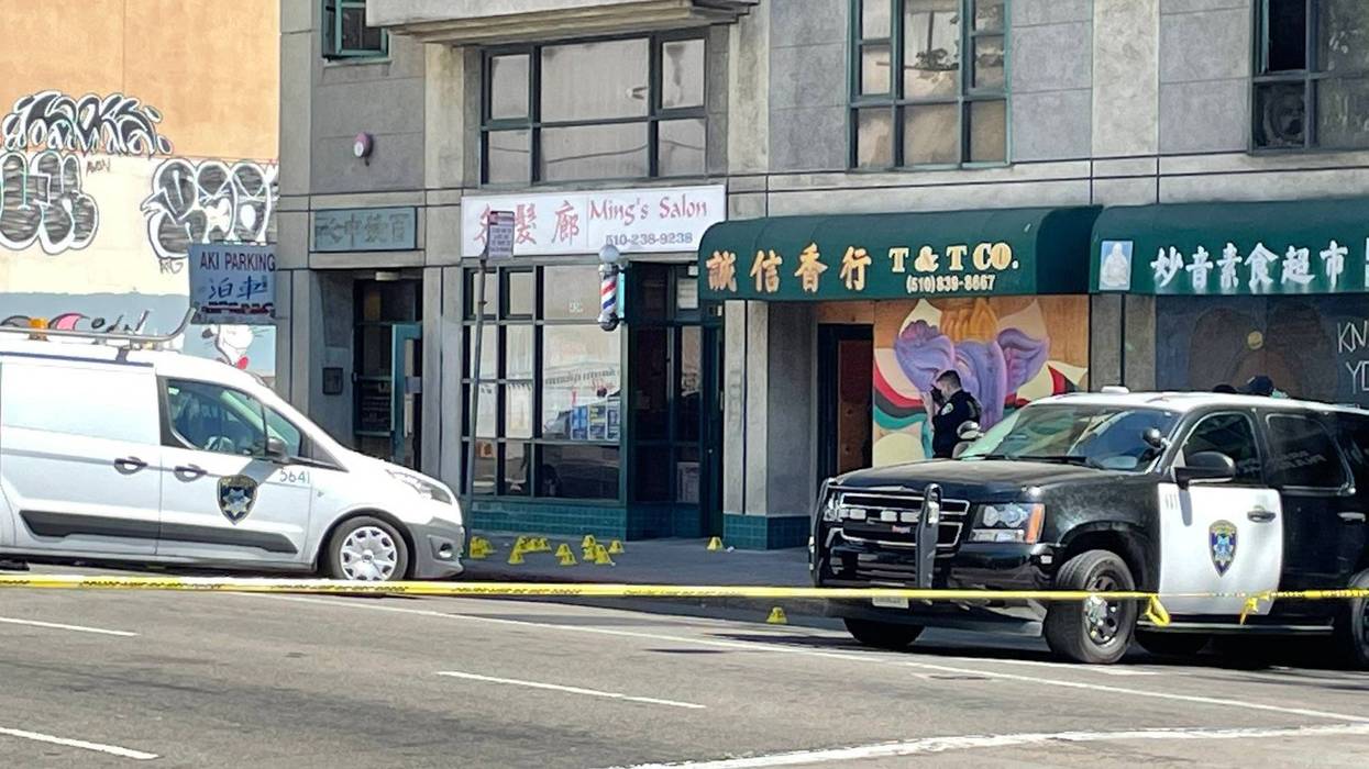 Police vehicles outside the scene of a shooting in Oakland's Chinatown District on Monday afternoon.