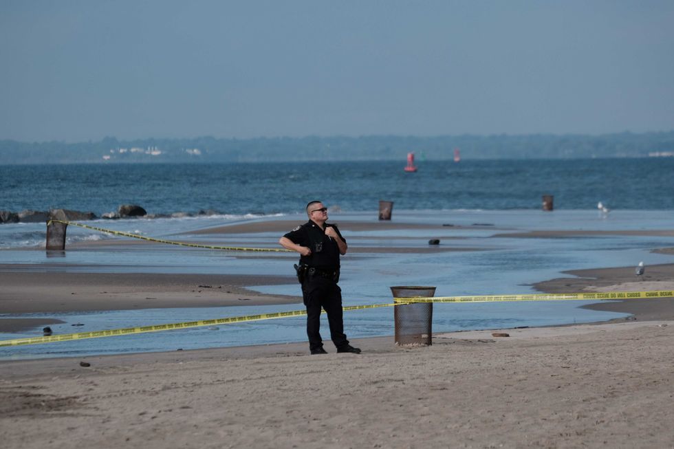 Police work along a stretch of beach at Coney Island which is now a crime scene after a mother is suspected of drowning her children in the ocean on September 12, 2022 in Brooklyn