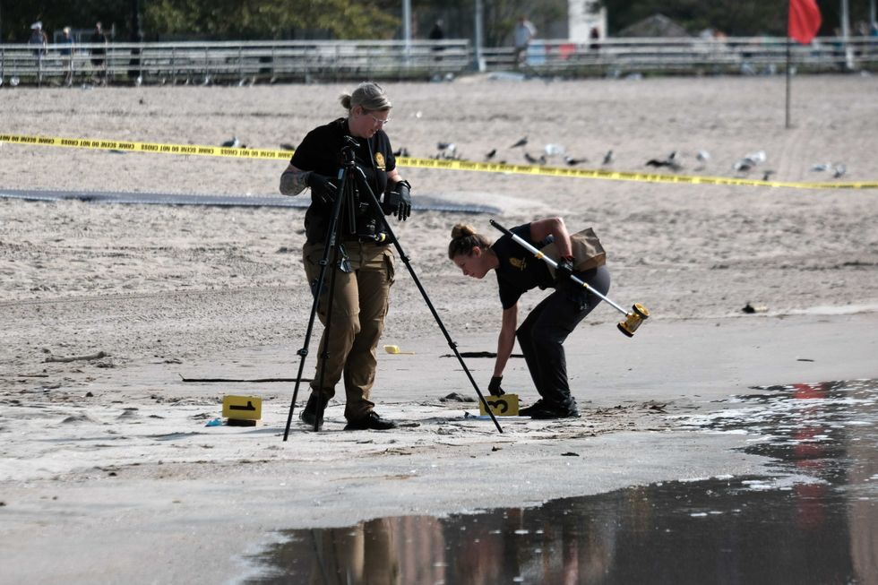 Police work along a stretch of beach at Coney Island which is now a crime scene after a mother is suspected of drowning her children in the ocean on September 12, 2022 in Brooklyn
