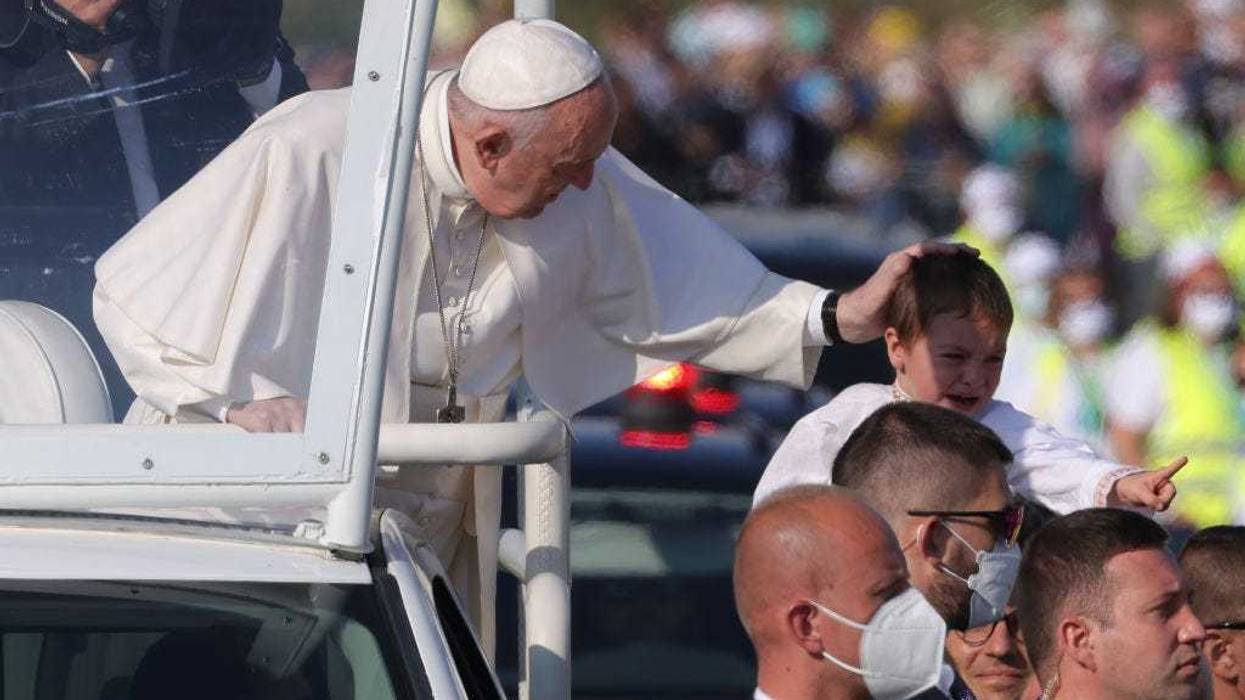 Pope Francis blesses a child while riding his Pope mobile through a crowd of pilgrims before holding an open-air mass on September 15, 2021 in Sastin, Slovakia. Today's mass concludes an apostolic trip by the Pope to Central Europe from September 12 to 15. The Pontiff visited five cities, starting with Budapest, Hungary, for the closing mass of the 52nd International Eucharistic Congress, continuing with the Slovak capital Bratislava, and visiting Kosice, Presov and Sastin. Only fully vaccinated and a limited number of tested worshippers have been allowed to attend public gatherings on this occasion. (Photo by Sean Gallup/Getty Images)