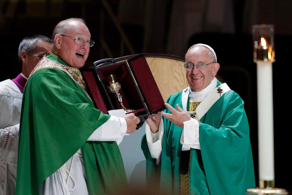 Pope Francis presents Cardinal Dolan, left, with a new chalice after celebrating Mass at Madison Square Garden on September 25, 2015