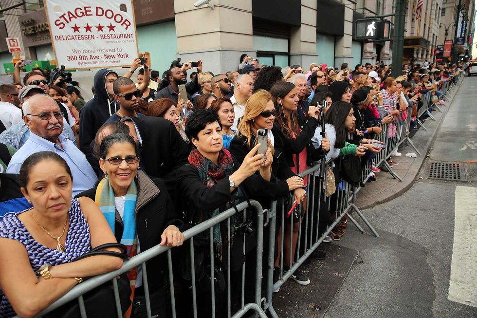 Pope Francis supporters gather outside of Madison Square Garden as he celebrates Mass on September 25, 2015