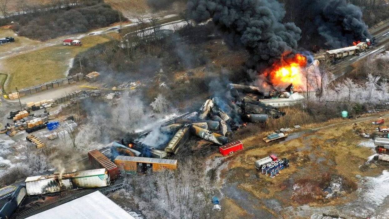 Portions of a Norfolk Southern freight train that derailed on Feb. 3, 2023, in East Palestine, Ohio, remain on fire the next day.