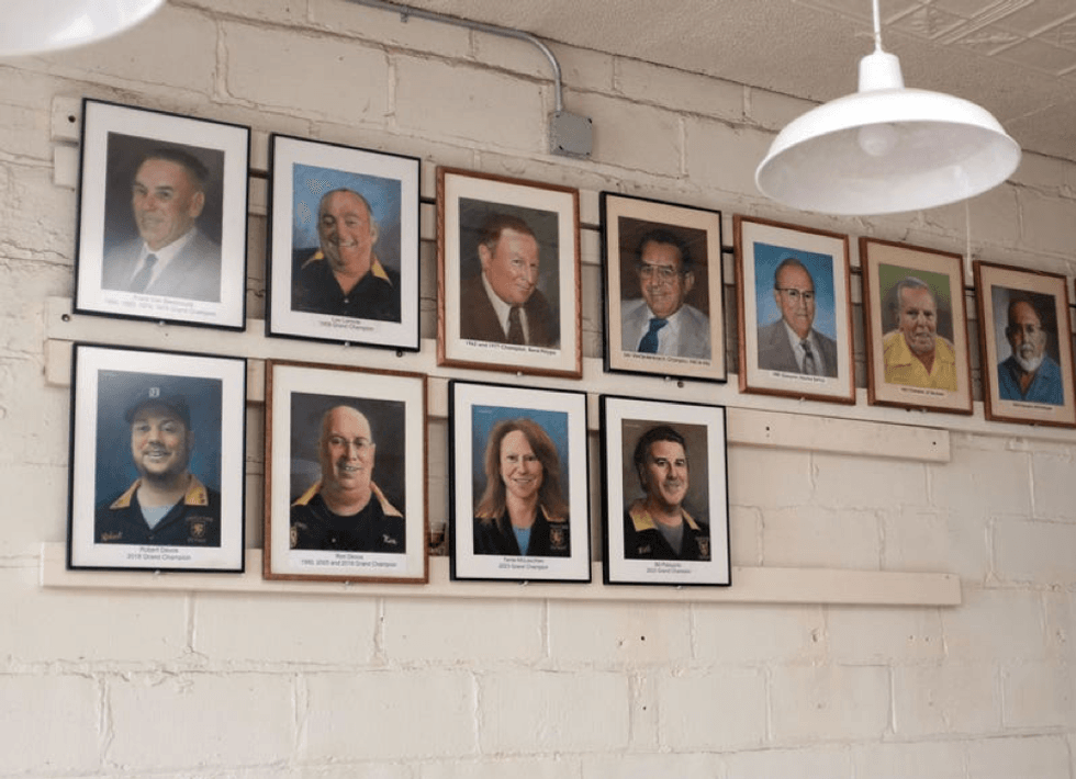 Portraits of feather bowling Grand Champions hang on the wall at the Cadieux Cafe in Detroit