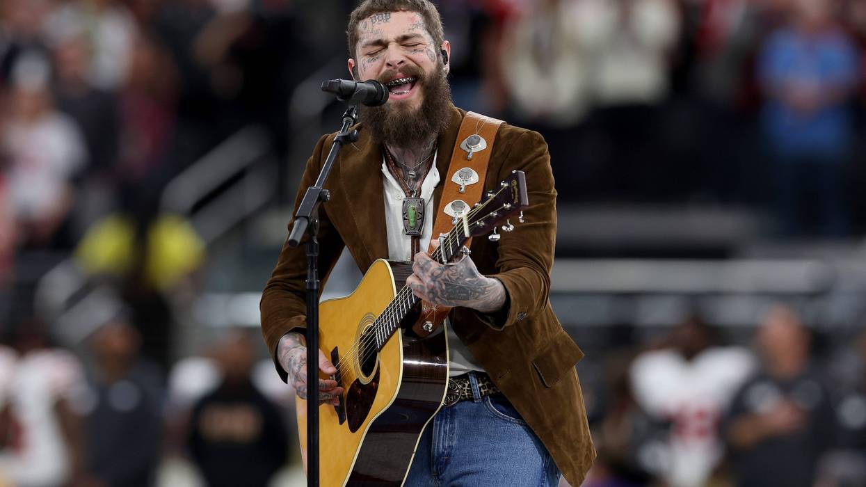 Post Malone performs with his guitar.