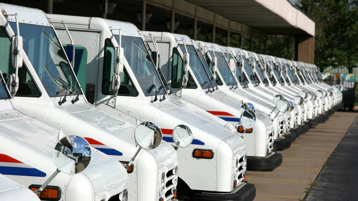 Postal delivery trucks - stock photo