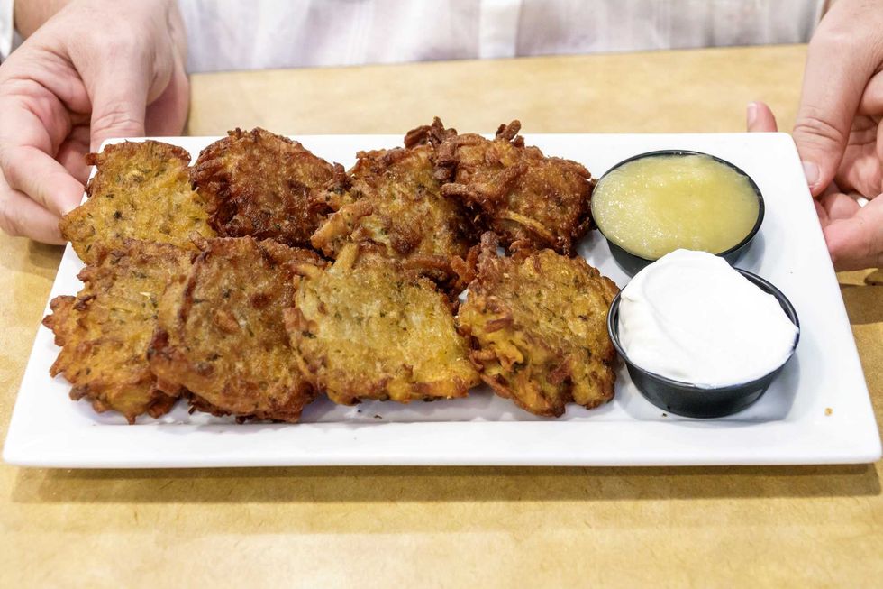 Potato latkes with sides of apple sauce and sour cream
