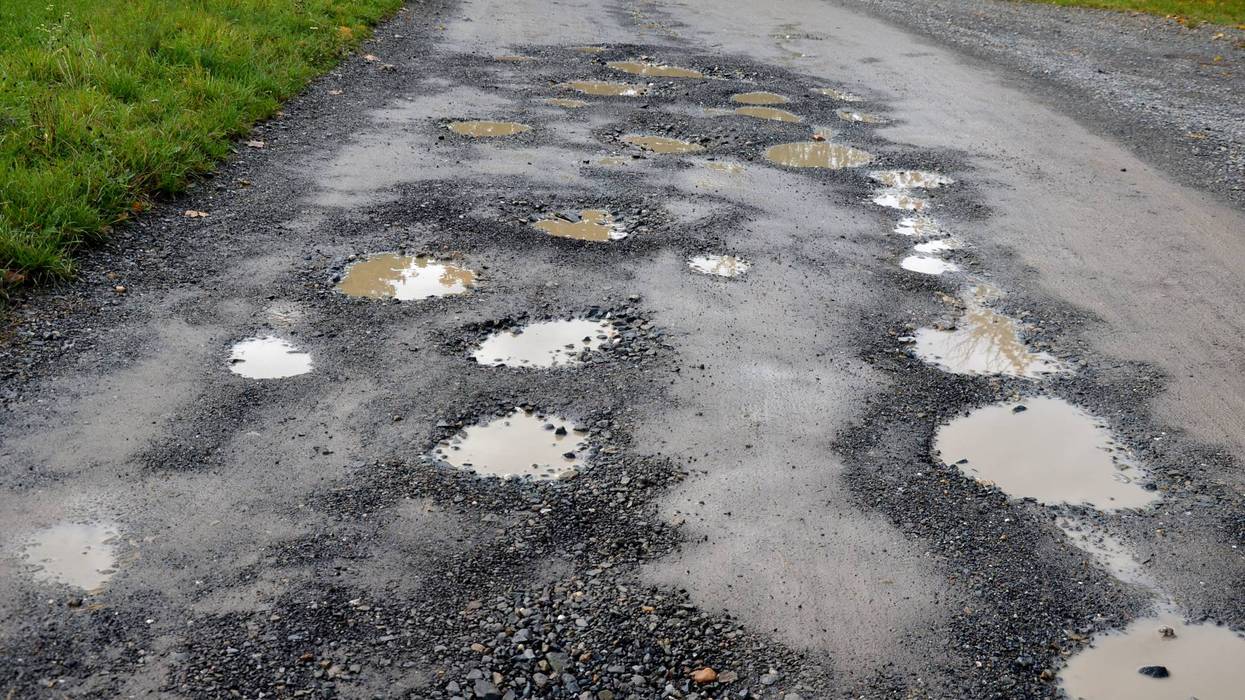 Potholes filled with water on road