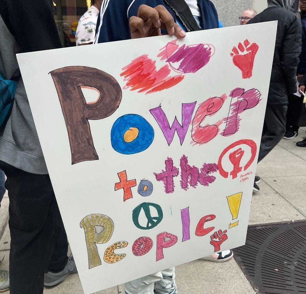 "Power to the people," reads a sign outside of a Chicago voting center.