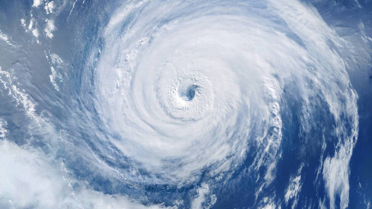 powerful hurricane seen from space with a clearly defined eye, showcasing the immense force of nature, swirling clouds, and the dramatic beauty of extreme weather over the ocean