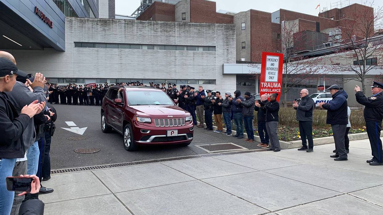 PPD applauding an officer as he's discharged from the hospital