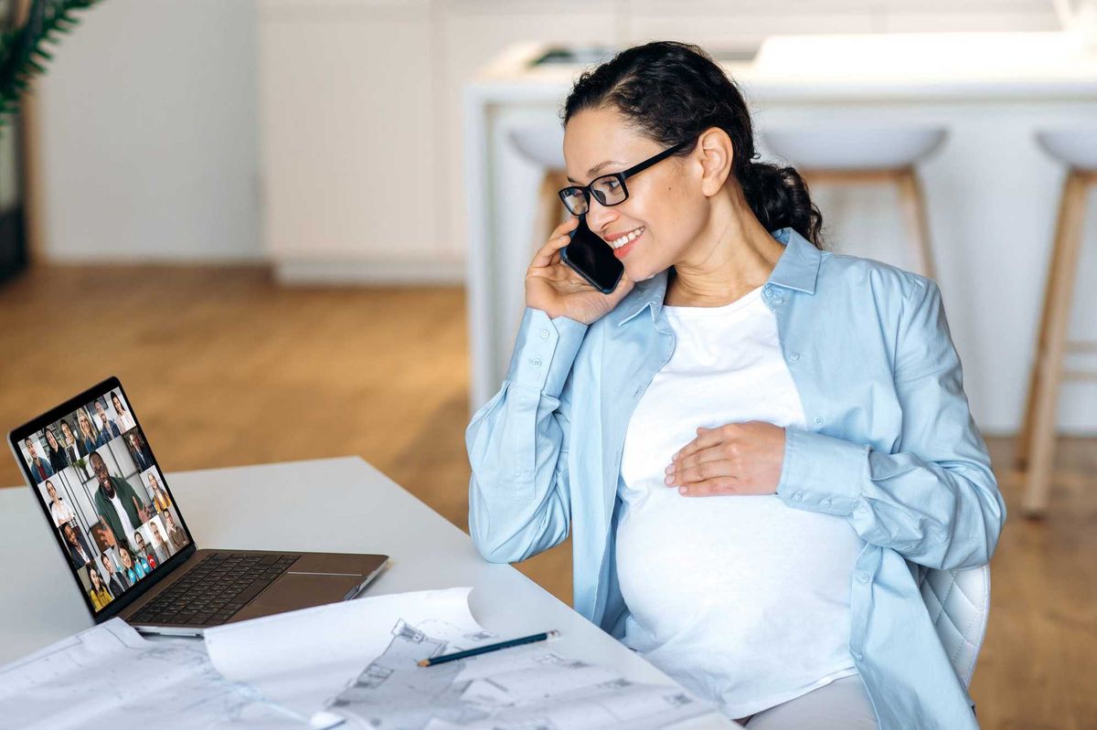 Pregnant woman at computer.