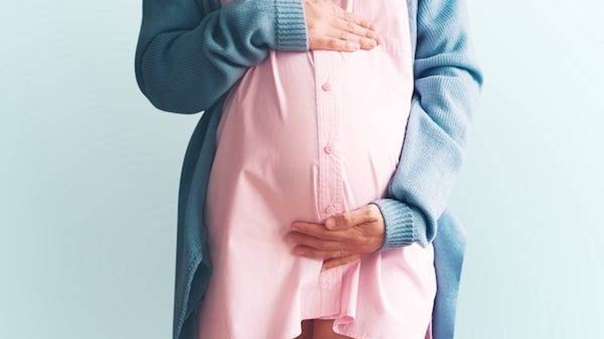 Pregnant woman holding hands on her belly