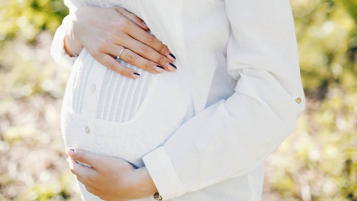Pregnant woman in park.