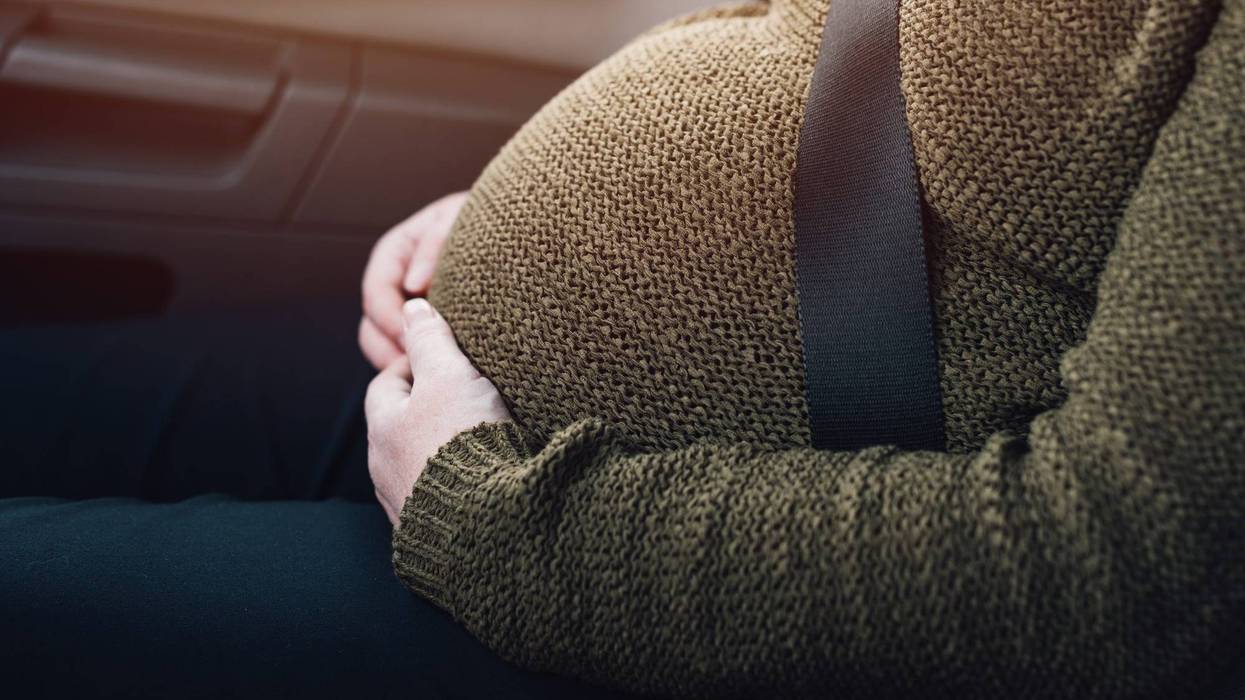 Pregnant woman seat belted in car