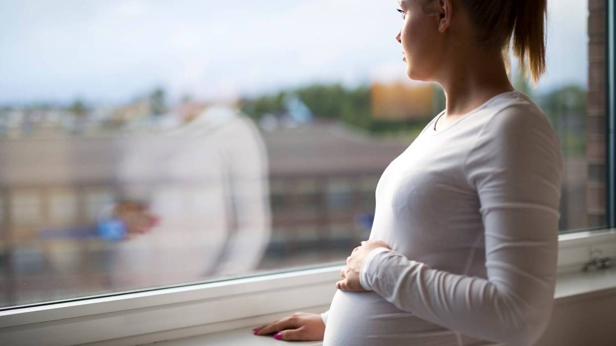Pregnant Woman Staring Out The Window