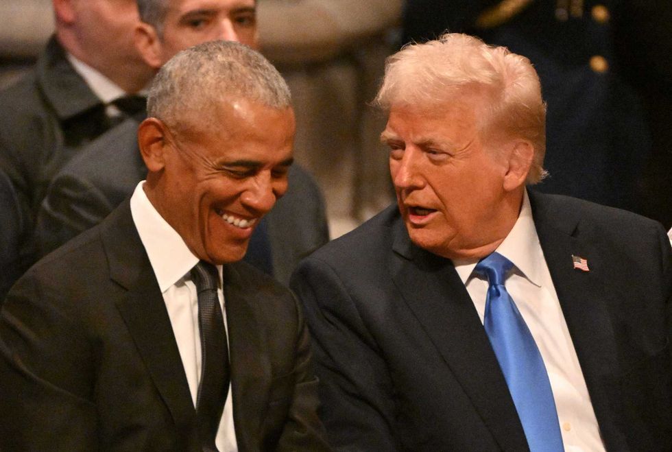 President Barack Obama speaks with President-elect Donald Trump before the State Funeral Service for former President Jimmy Carter at the Washington National Cathedral in Washington, DC, on January 9, 2025