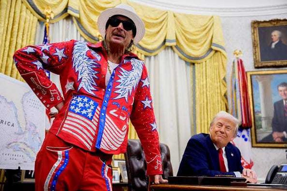 President Donald Trump, accompanied by entertainer Kid Rock, speaks during an executive order signing event in the Oval Office of the White House on March 31, 2025 in Washington, DC.