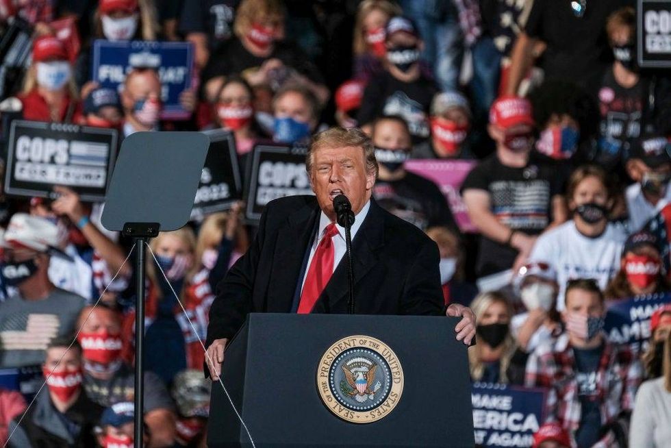 President Donald Trump addresses the crowd during a campaign event at the Toledo Express Airport in Swanton, Ohio on Monday