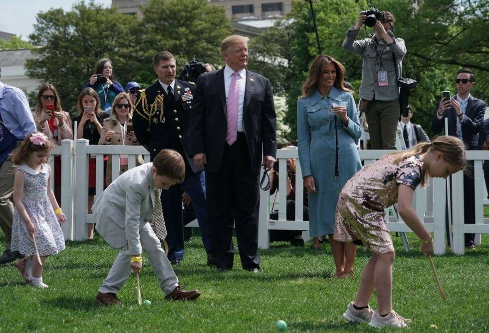 President Donald Trump and first lady Melania Trump watch children participating in the 141st Easter Egg Roll on the South Lawn of the White House April 22, 2019 in Washington, DC.