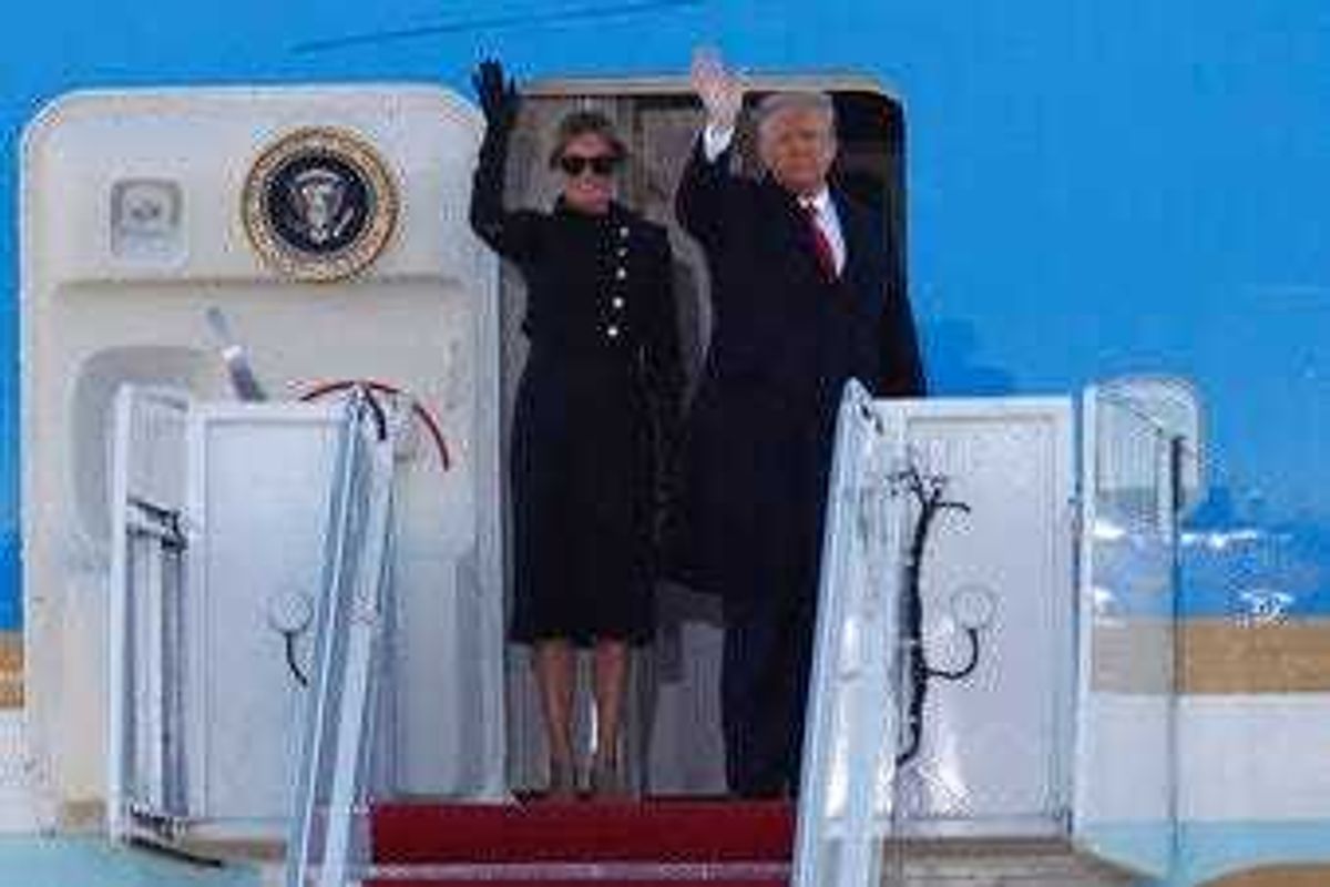President Donald Trump and first lady Melania Trump wave to a crowd as they board Air Force One at Andrews Air Force Base, Md., Wednesday, Jan. 20, 2021. (AP Photo/Luis M. Alvarez)