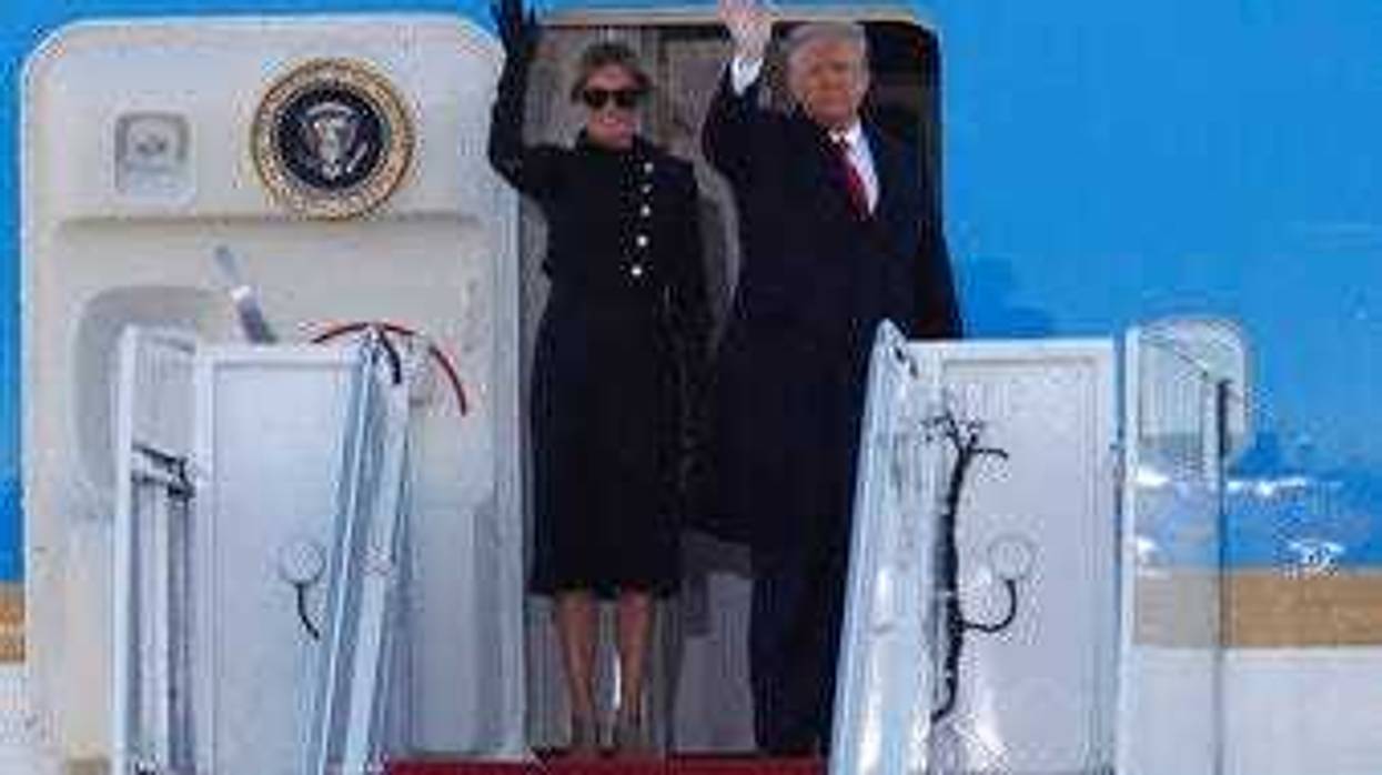 President Donald Trump and first lady Melania Trump wave to a crowd as they board Air Force One at Andrews Air Force Base, Md., Wednesday, Jan. 20, 2021. (AP Photo/Luis M. Alvarez)