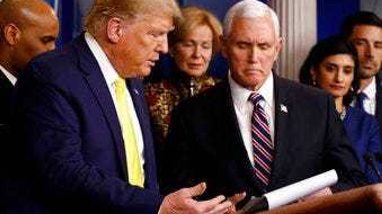 President Donald Trump gestures for Vice President Mike Pence to speak in the briefing room of the White House in Washington, Monday, March 9, 2020, about the coronavirus outbreak. (AP Photo/Patrick Semansky)