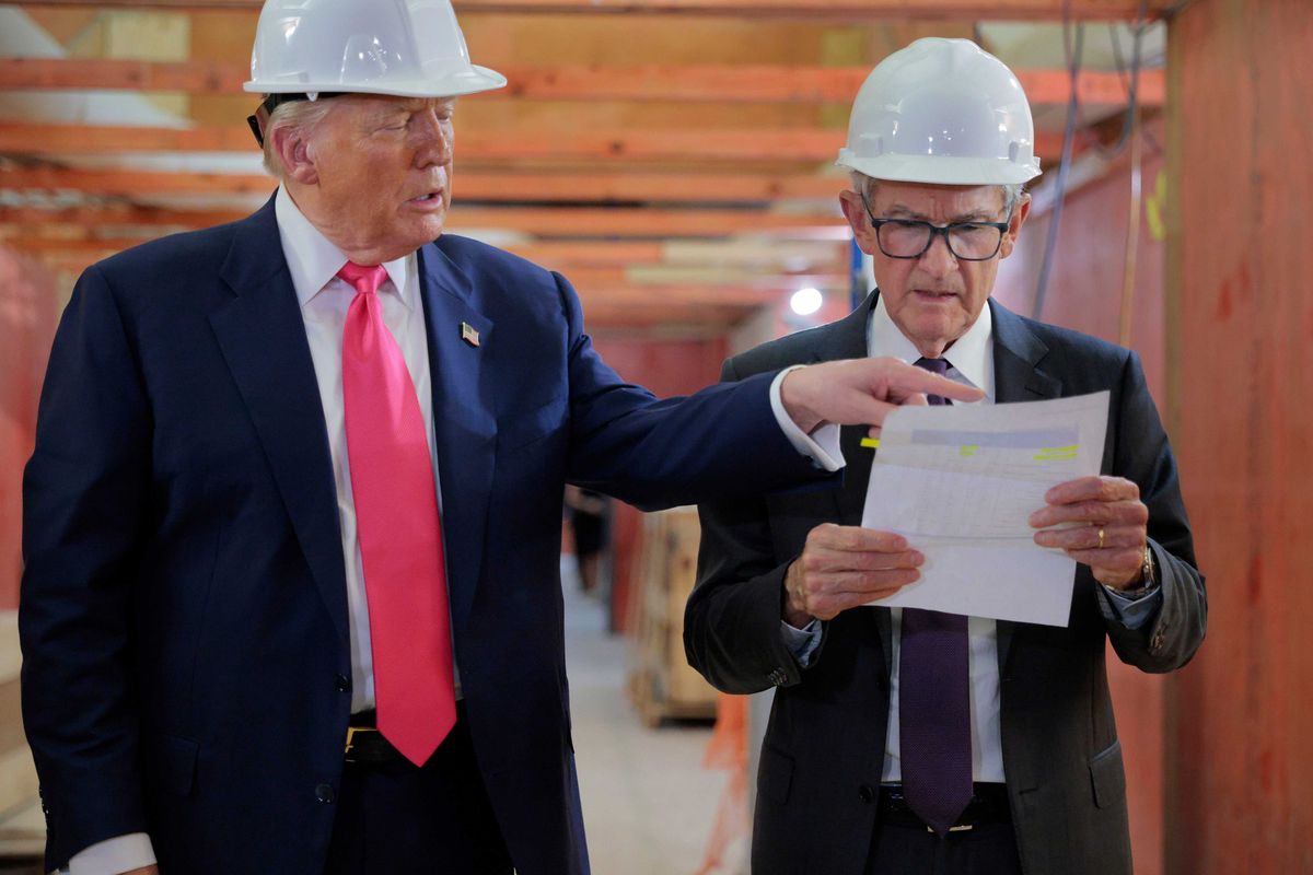 President Donald Trump presents Federal Reserve Chair Jerome Powell with what he Trump called a list of cost overruns for the Federal Reserve’s $2.5 billion headquarters renovation project on July 24, 2025 in Washington, DC. Trump has recently threatened to oust Powell because, according to the president, the bank has not lowered interest rates fast enough.