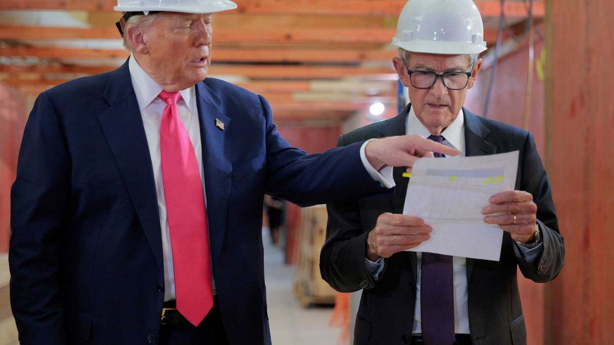 President Donald Trump presents Federal Reserve Chair Jerome Powell with what he Trump called a list of cost overruns for the Federal Reserve’s $2.5 billion headquarters renovation project on July 24, 2025 in Washington, DC. Trump has recently threatened to oust Powell because, according to the president, the bank has not lowered interest rates fast enough.