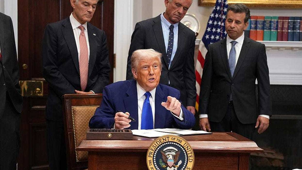 President Donald Trump signs an executive order aimed at reducing the cost of prescription drugs and pharmaceuticals by 30% to 80% during an event in the Roosevelt Room of the White House on May 12, 2025, in Washington, DC.