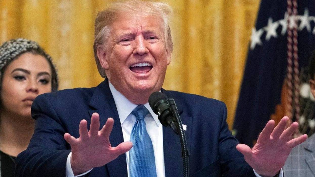 President Donald Trump speaks at the Young Black Leadership Summit 2019 in the East Room of the White House in Washington, Friday, Oct. 4, 2019. Kearyn Bolin, back left, of Texas State University listens.