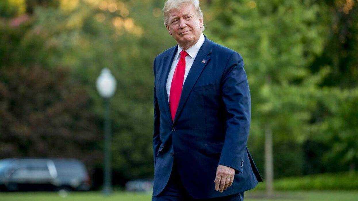 President Donald Trump walks across the South Lawn as he arrives at the White House