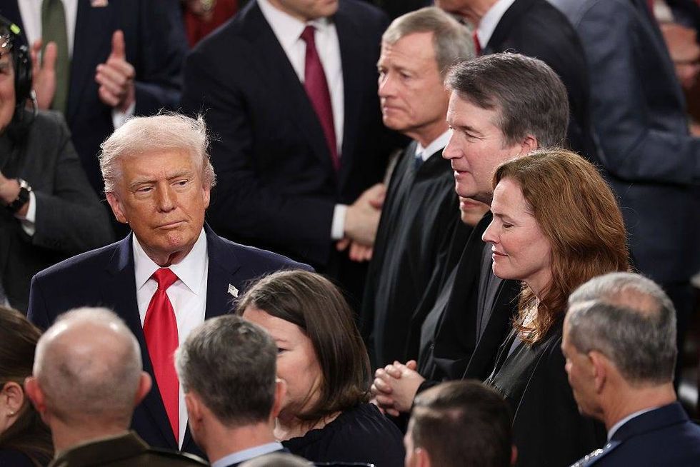 President Donald Trump walks past Supreme Court Chief Justice John Roberts, Associate Justice Elena Kagan, Associate Justice Brent Kavanaugh and Associate Justice Mary Coney Barrett as he arrives for the State of the Union address during a Joint Session of Congress at the U.S. Capitol on February 24, 2026, in Washington, DC.
