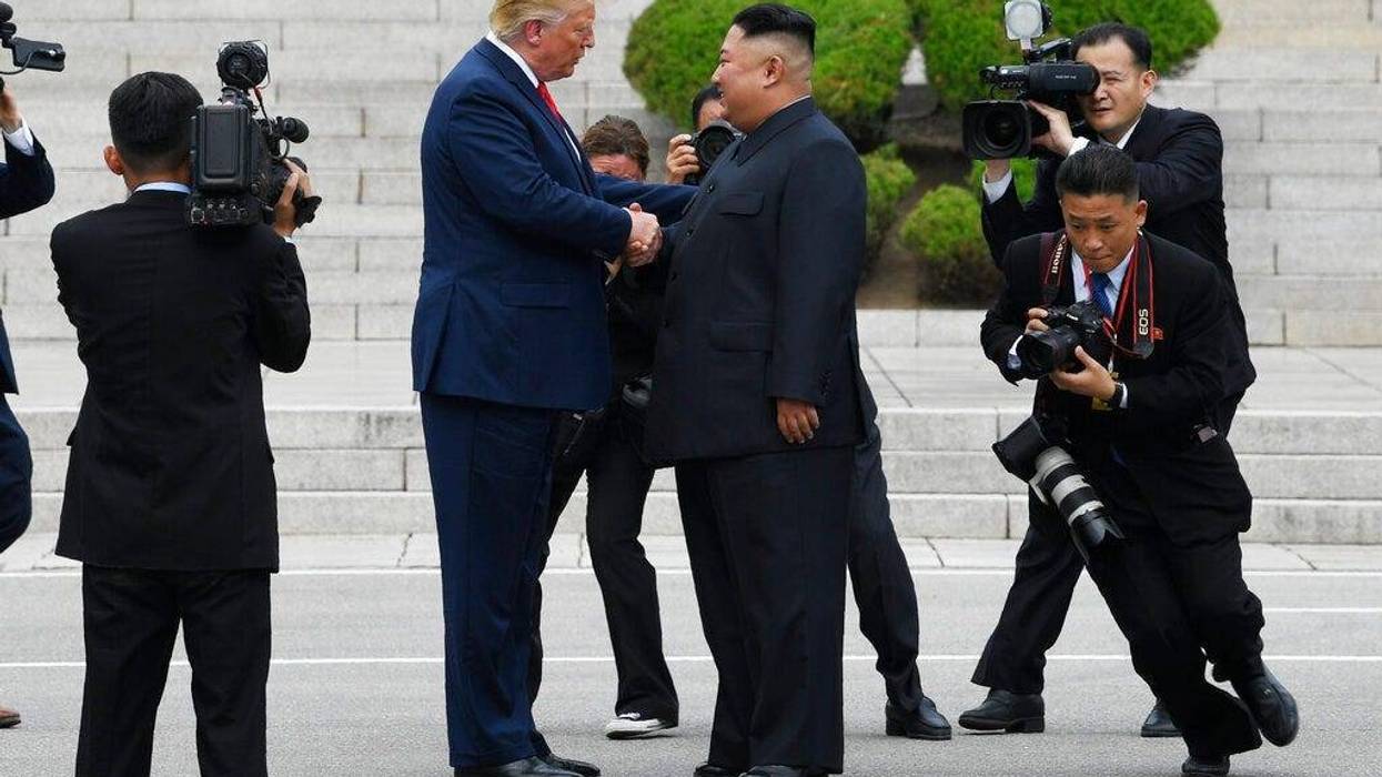 President Donald Trump walks to the North Korean side of the border with North Korean leader Kim Jong Un at the border village of Panmunjom in the Demilitarized Zone, Sunday, June 30, 2019, in North Korea.