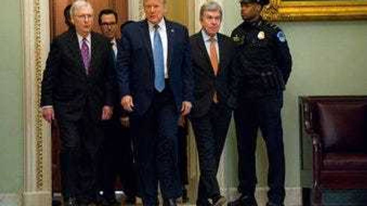 President Donald Trump walks with Senate Majority Leader Mitch McConnell of Ky., to a meeting with lawmakers on Capitol Hill, Tuesday, March 10, 2020, in Washington. (AP Photo/Evan Vucci)