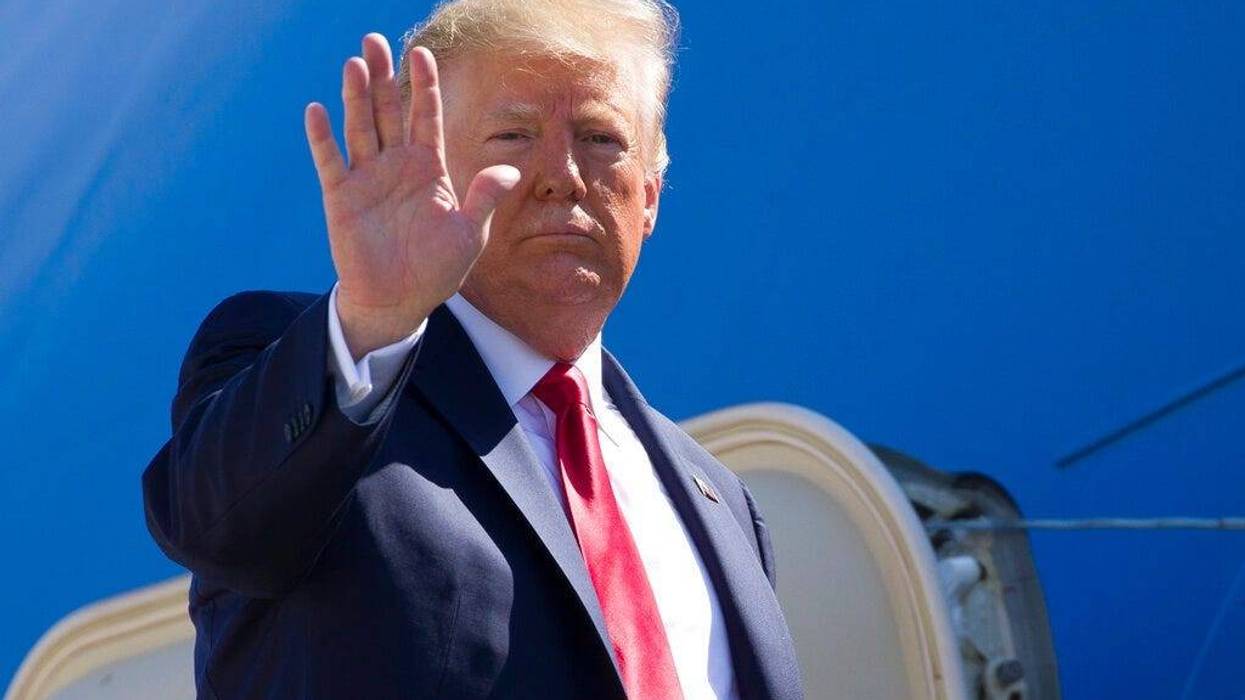 President Donald Trump waves as he boards Air Force One