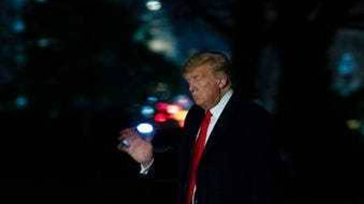 President Donald Trump waves as he walks on the South Lawn of the White House, with the U.S. Capitol in the background, after returning on Marine One, Thursday, Jan. 23, 2020, in Washington. (AP Photo/Alex Brandon)
