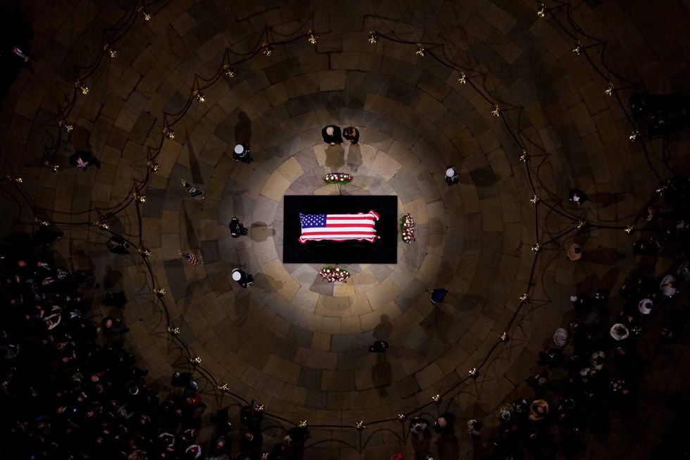 President-elect Donald Trump and his wife former First Lady Melania Trump visit the flag-draped casket of former U.S. President Jimmy Carter lies in state in the U.S. Capitol Rotunda on January 8, 2025 in Washington, DC